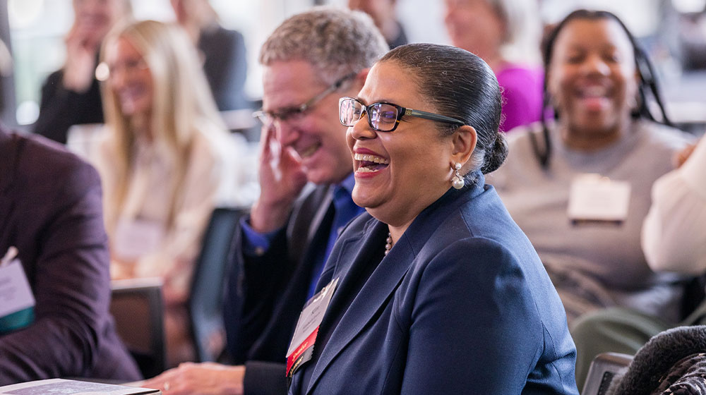 Woman attending a conference smiling and laughing