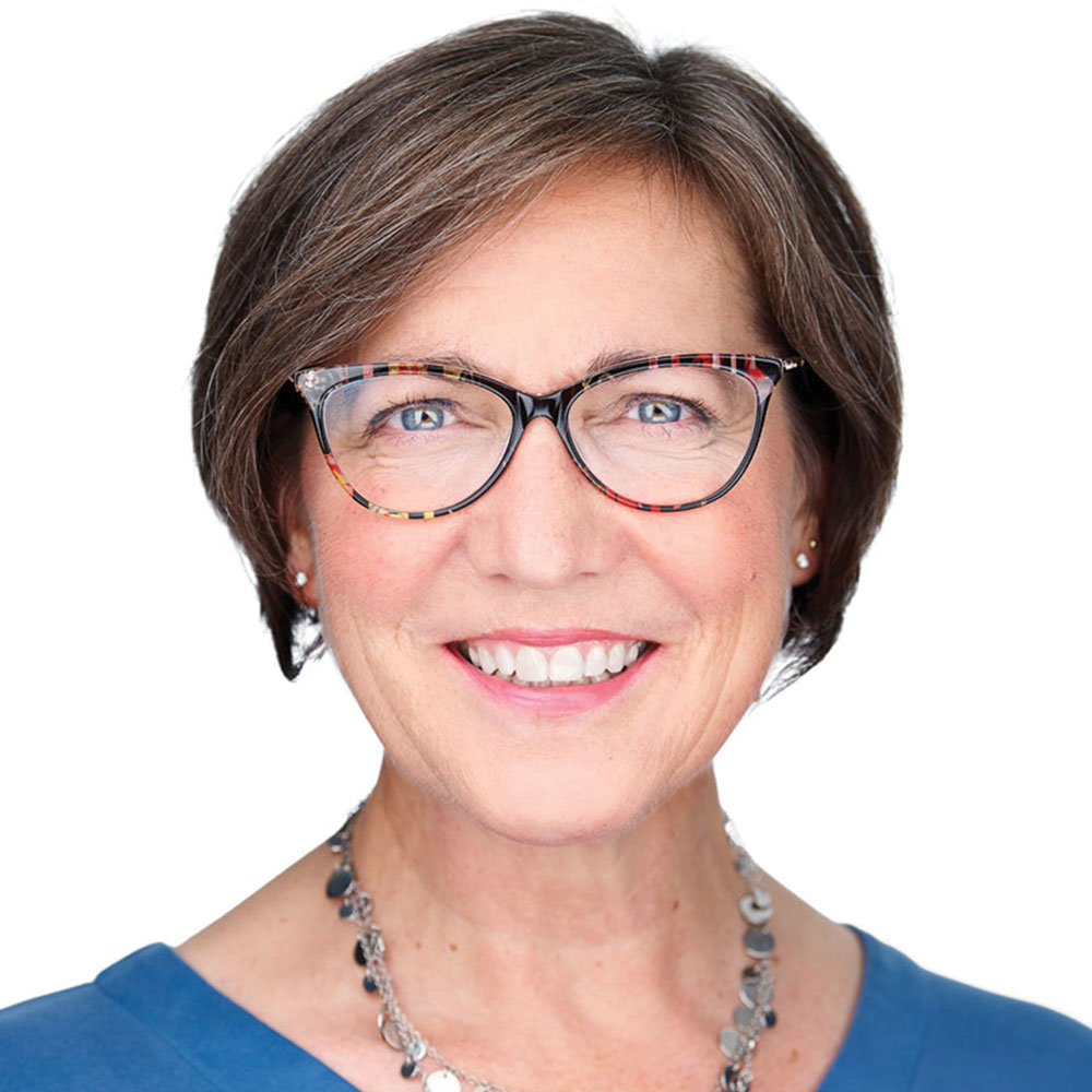 Karyn Linn smiles while facing the camera for a professional headshot against a white background. She is wearing glasses and a blue shirt. Karyn Linn smiles while facing the camera for a professional headshot against a white background. She is wearing glasses and a blue shirt.