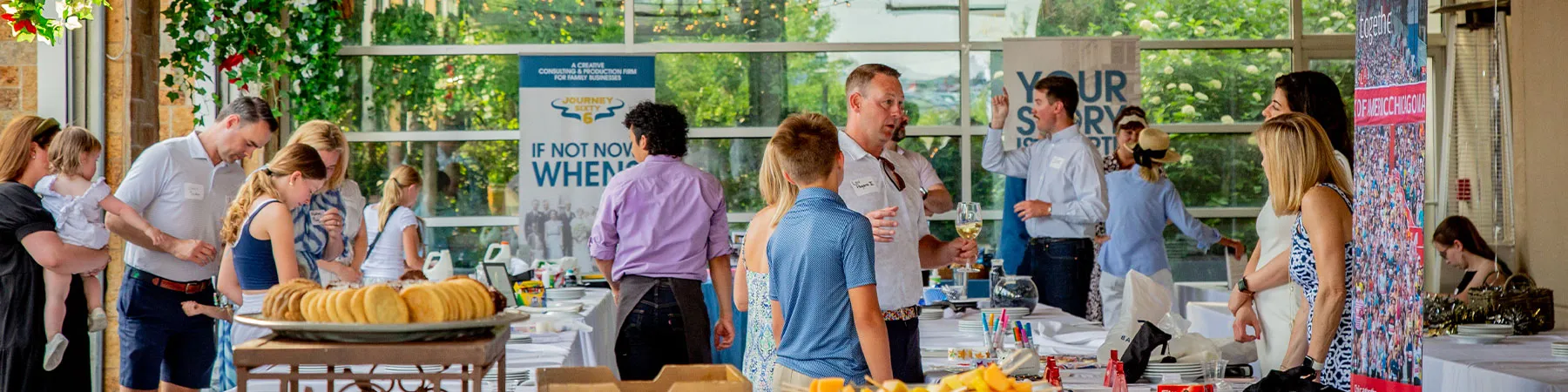 Attendees of the family business summer social mingling outside