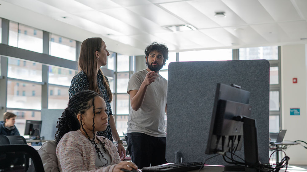 A student completes research alongside Quinlan faculty and staff.