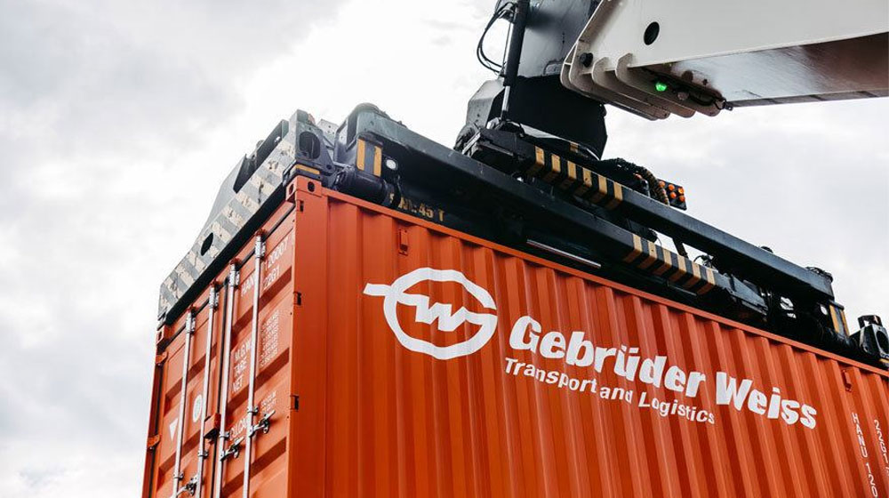 Freight container being hoisted by crane