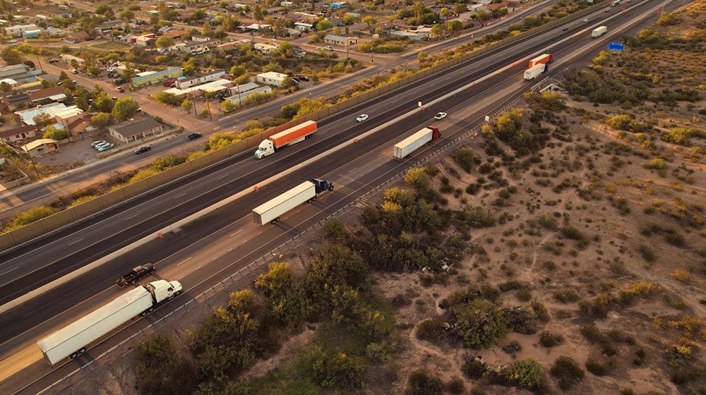 Aerial shot of a highway with vehicles and trucks Aerial shot of a highway with vehicles and trucks