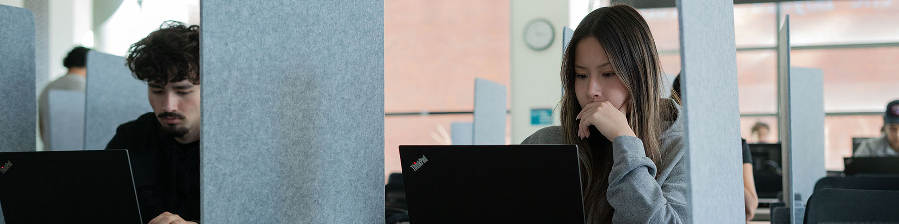 Students with laptops sit in the behavioral lab