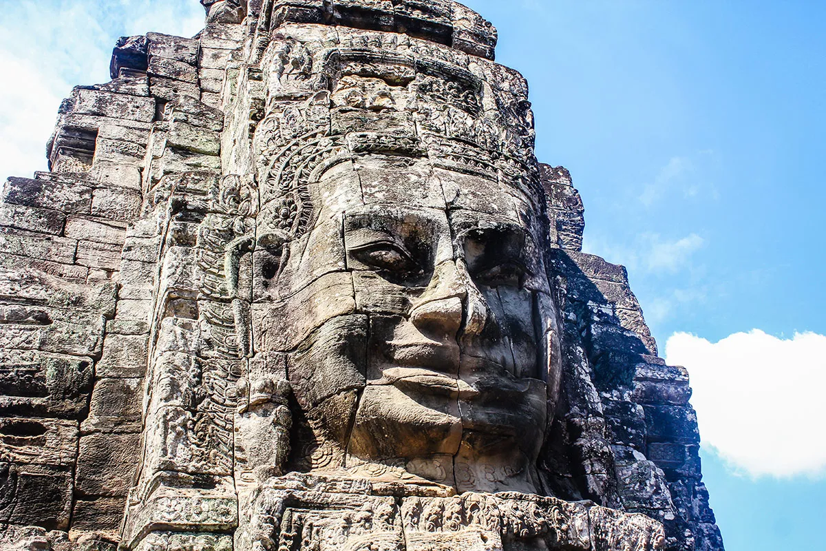 A relief sculpture in the side of a mountain at a travel destination in Cambodia