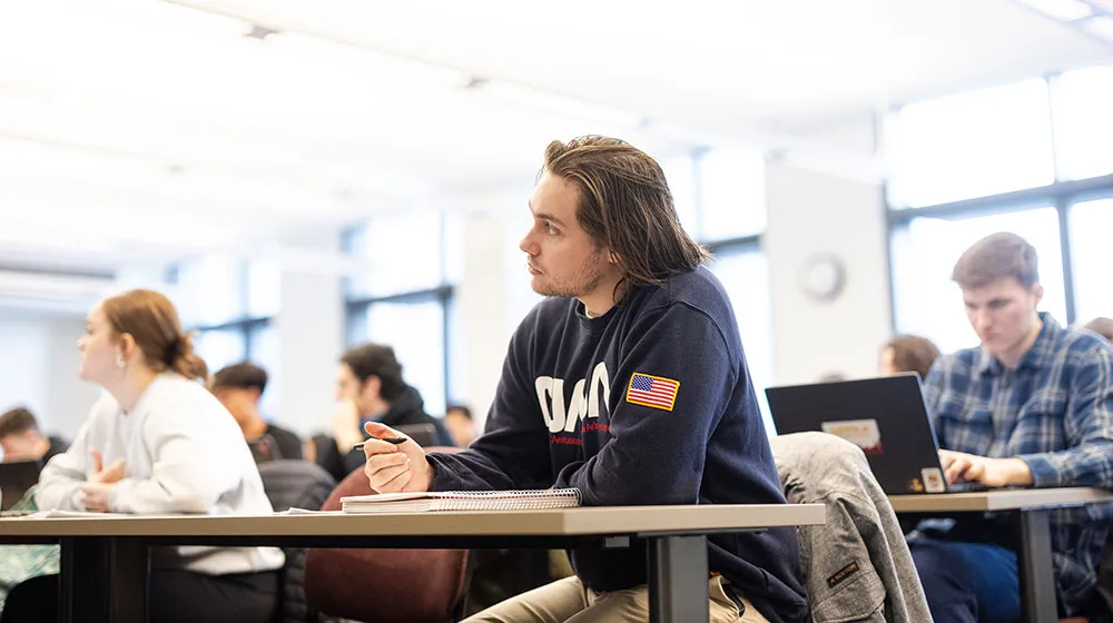 A student in Abraham Singers class listens intently as the professor speaks.