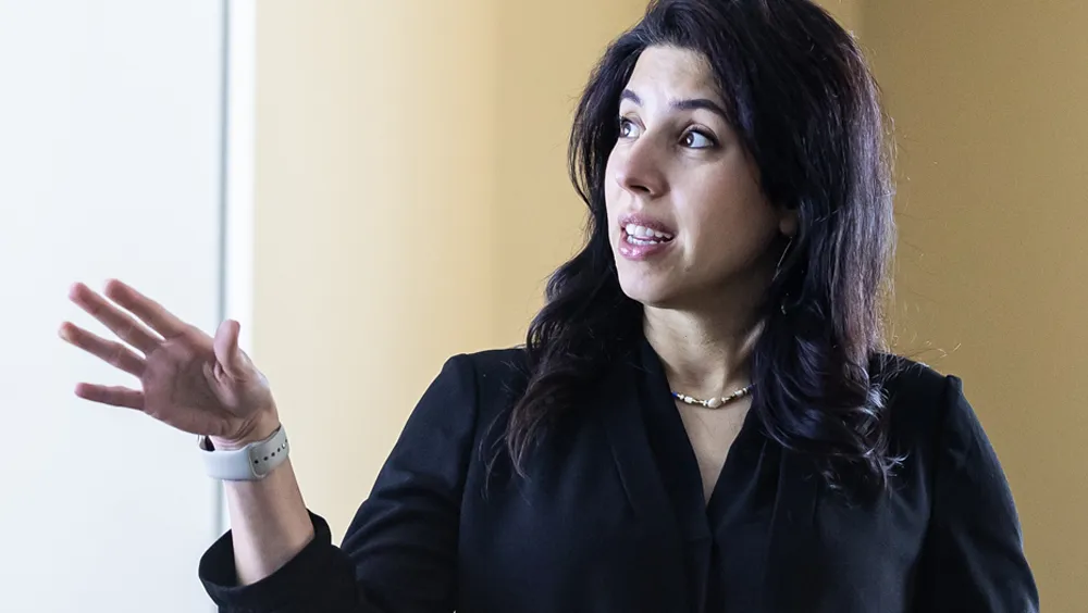 Shabnam Azimi engages with students as she teaches in the classroom.