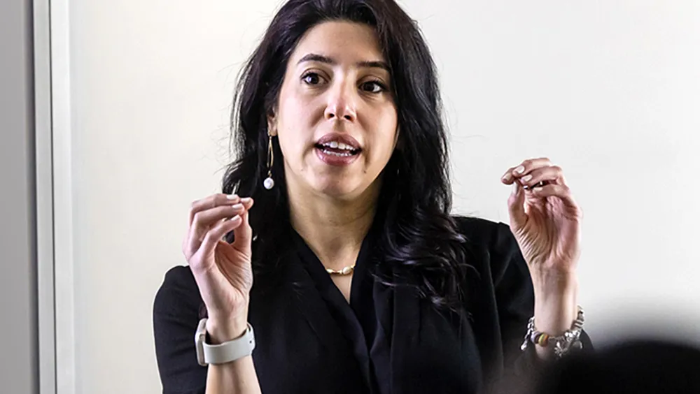 Shabnam Azimi engages with students as she teaches in the classroom.
