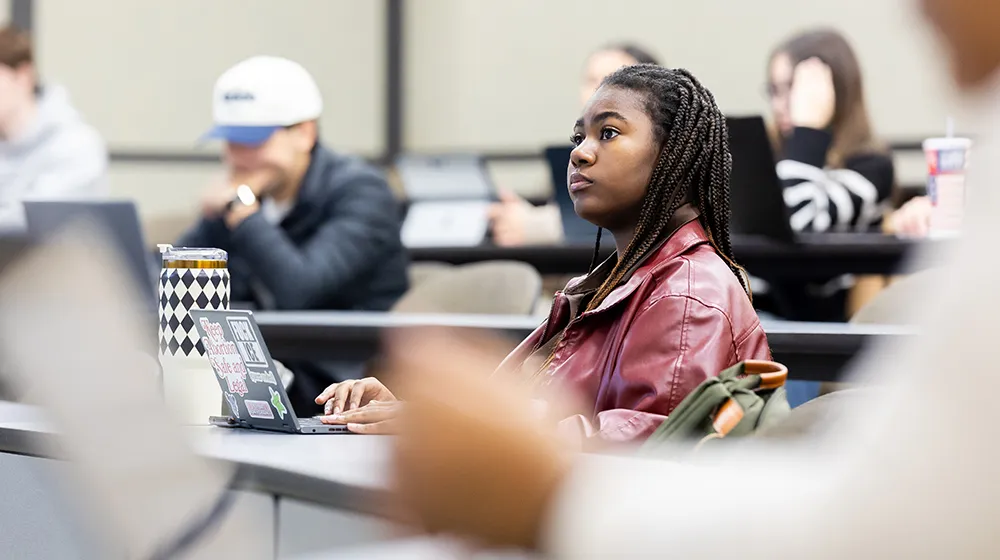  A student dressed in a red leather jacket listens attentively in Yuxiao Rain Luo's classroom.