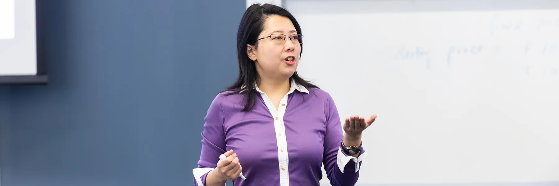 Longfei Lisa Yang engages with students as she teaches in the classroom.