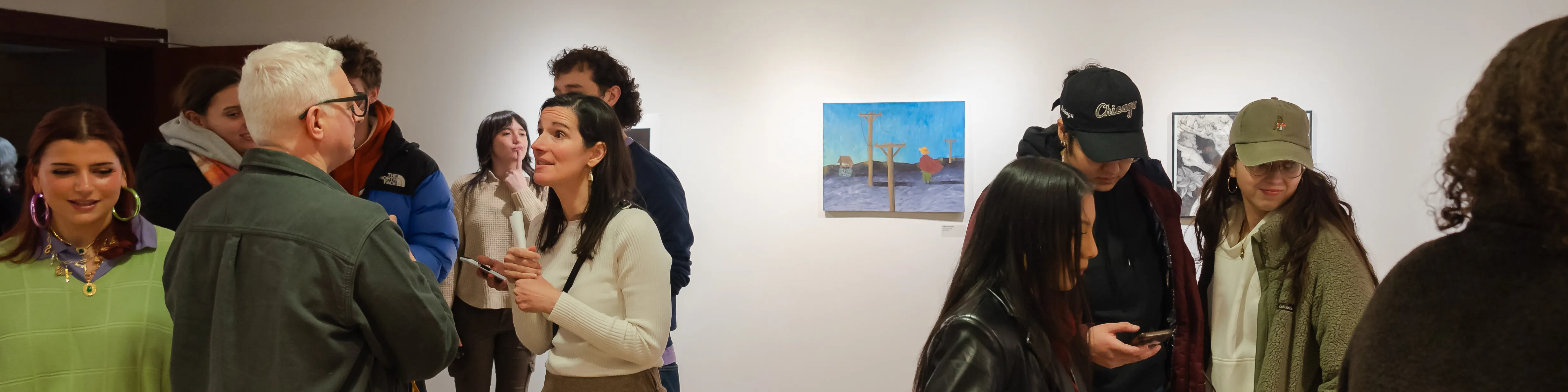 Loyola Fine Arts faculty and students at an opening reception in Ralph Arnold Gallery