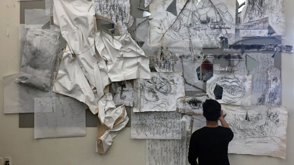 A student in Rafael Vera’s FNAR 213: Drawing II course completing a collaborative project 