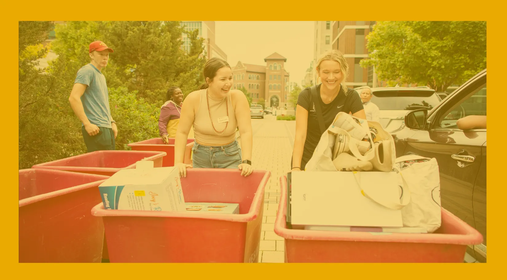 Loyola University Chicago students pushing carts filled with belongings on move-in day
