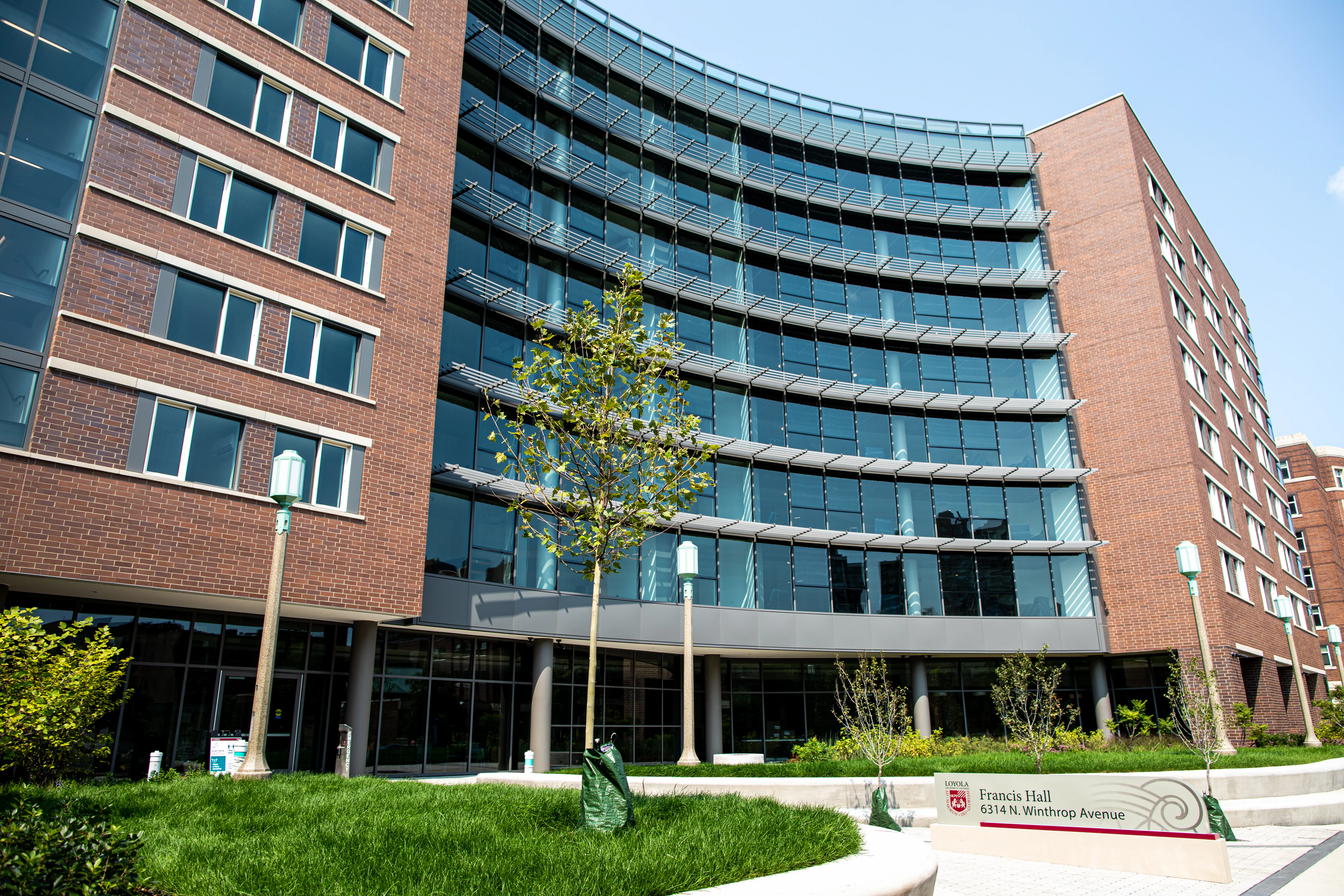 Exterior view of Francis Hall, a Loyola University Chicago residence hall, with landscaped campus grounds