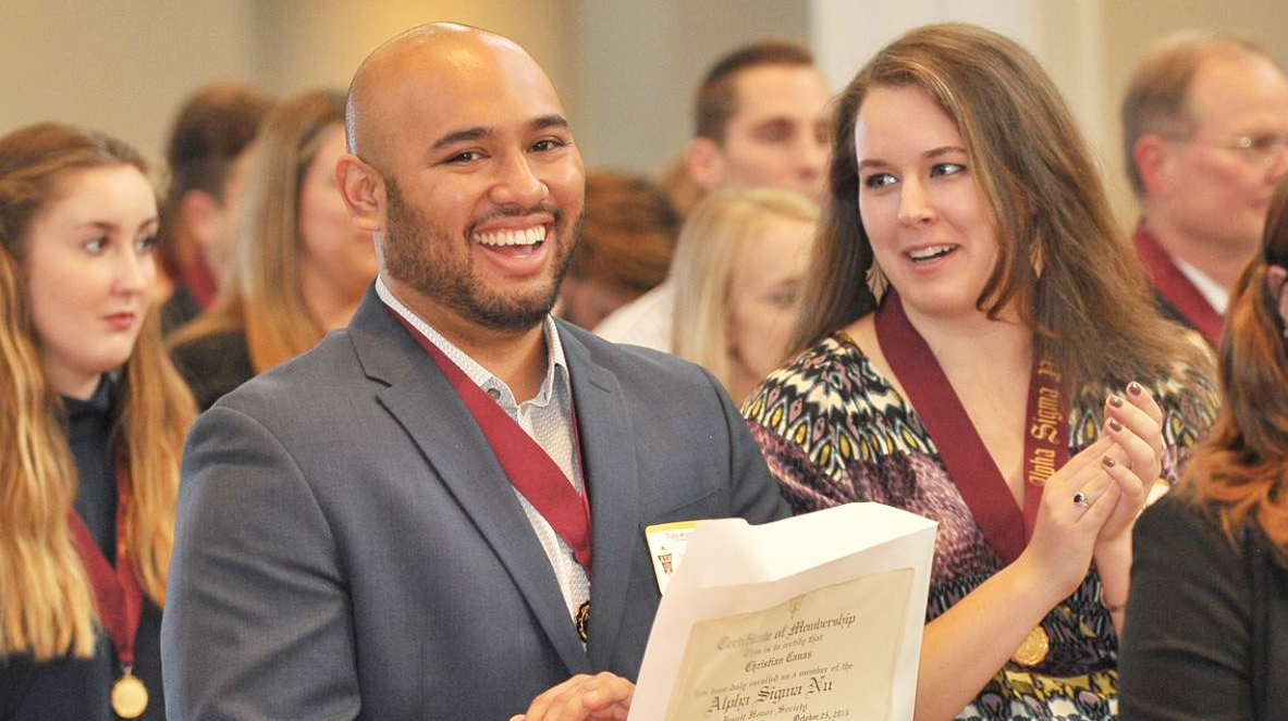 Loyola Chicago Alpha Sigma Nu Inductees sitting talking Loyola Chicago Alpha Sigma Nu Inductees sitting talking