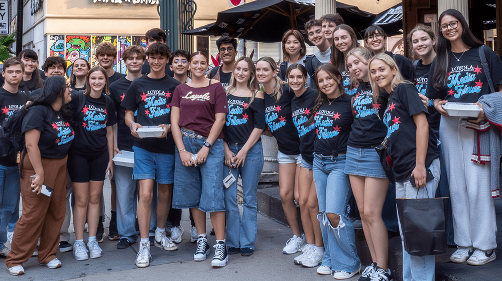 SOC Media Fellows stand outside of Uno's Pizzeria smiling