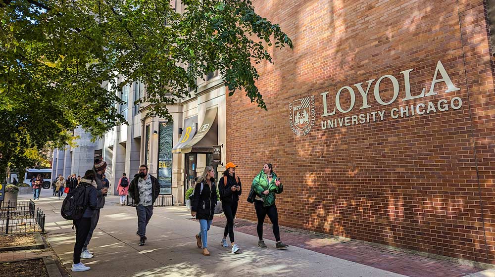 Students walk in front of Maguire Hall