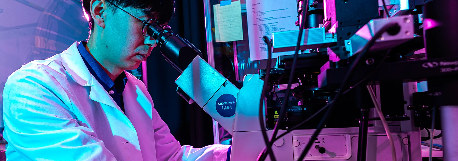 Man Looking into microscope