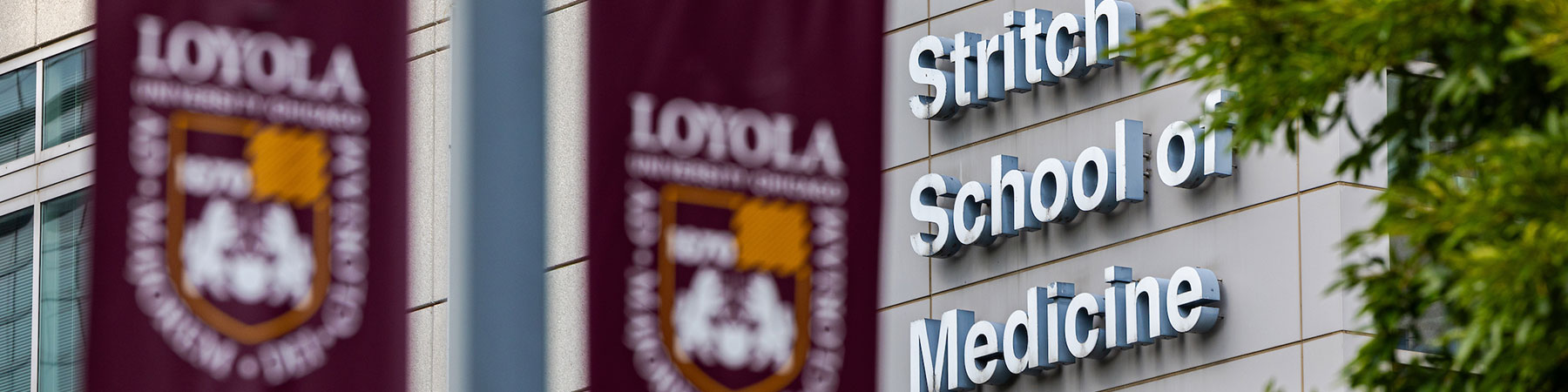 Stritch exterior building with Loyola banners