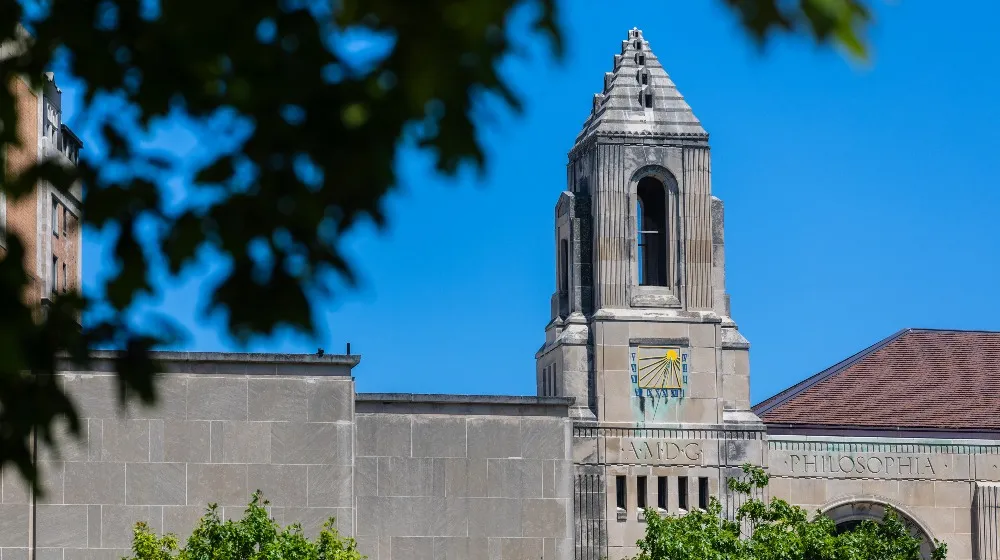 The clock tower of Cudahy Library against a blue sky. The clock tower of Cudahy Library against a blue sky.