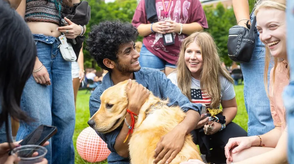 Loyola University Chicago students interact with a therapy dog at the Wellness Center Loyola University Chicago students interact with a therapy dog at the Wellness Center