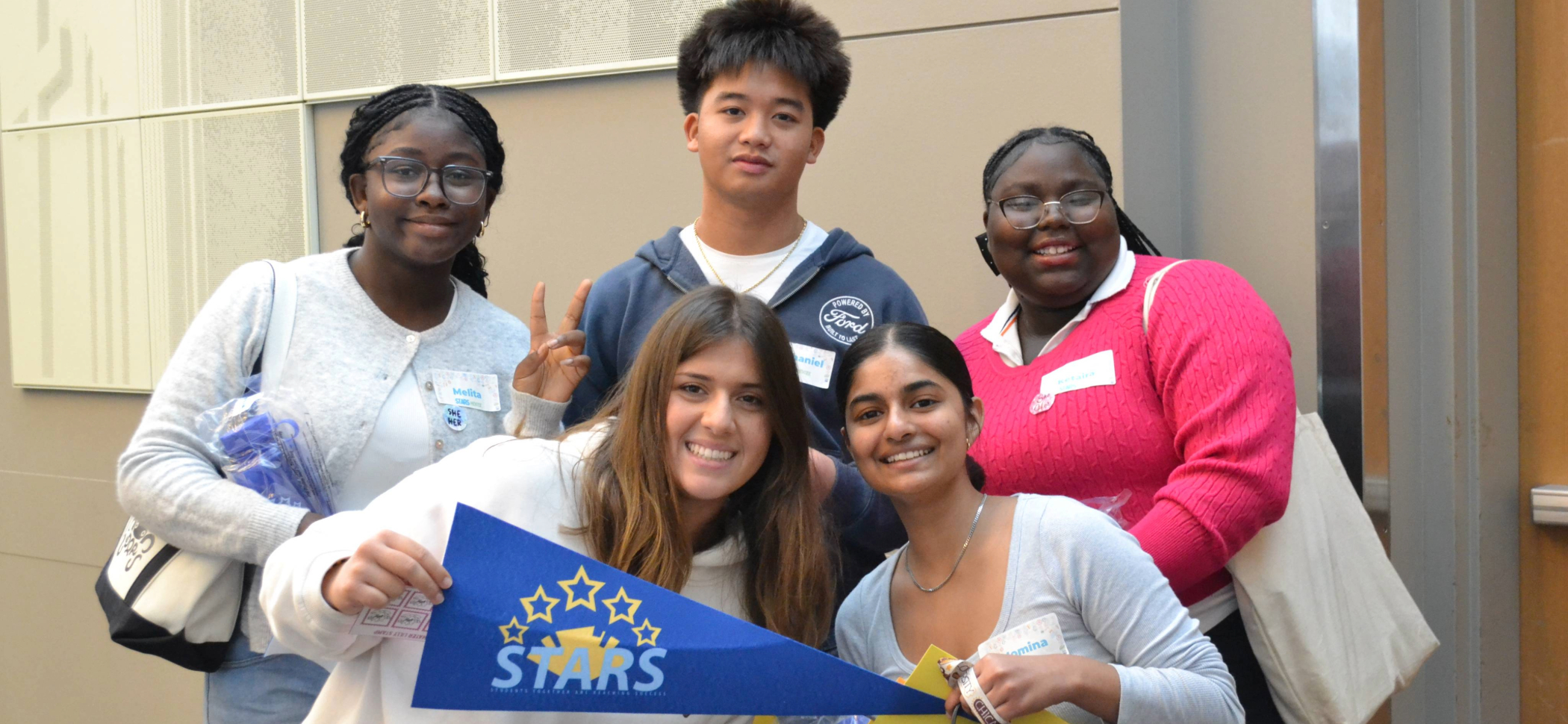 Group of five CSIB employees smiling and posing for a picture outside.