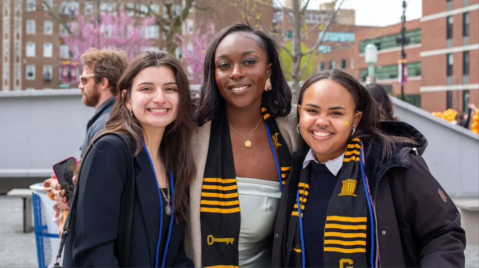 Students smile and pose together at the graduation celebrations.