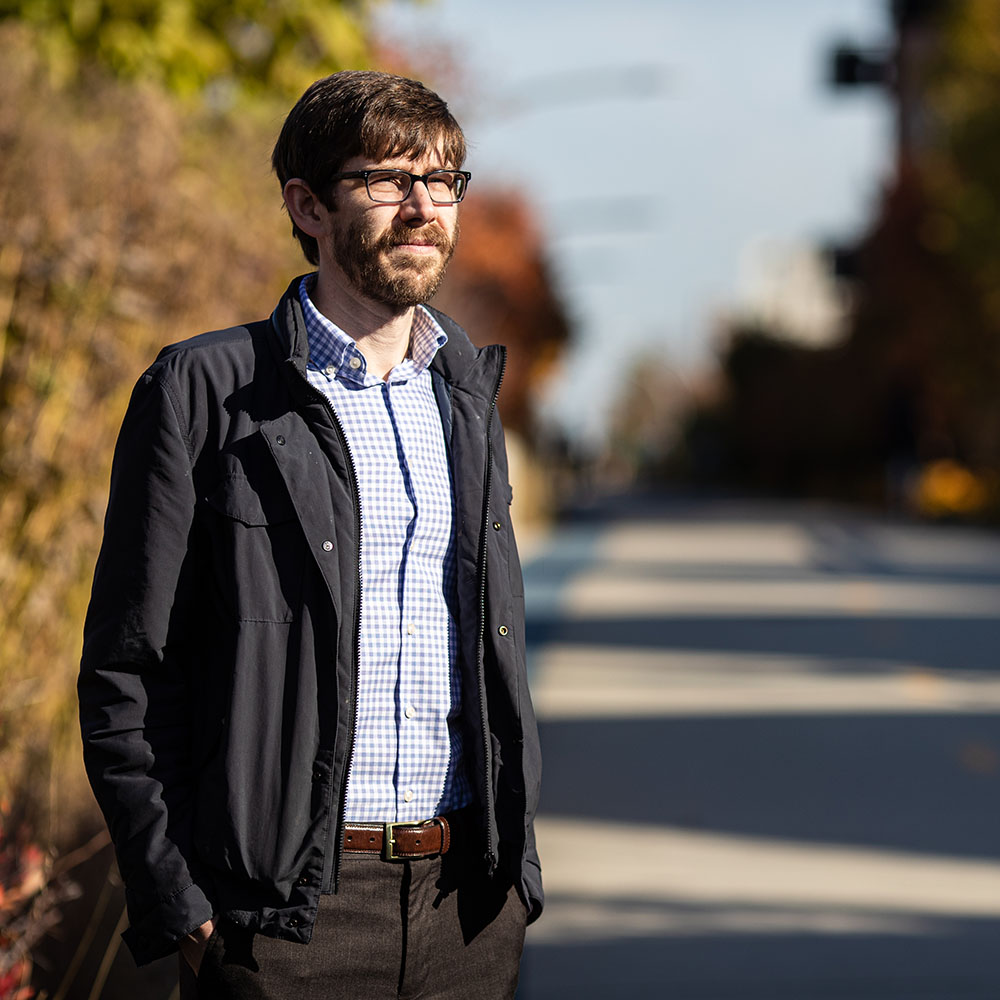 Max Melstrom standing in front of a walking and biking path