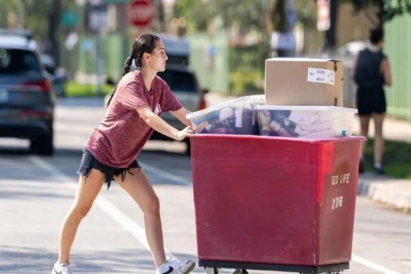Student pushing move in cart Student pushing move in cart