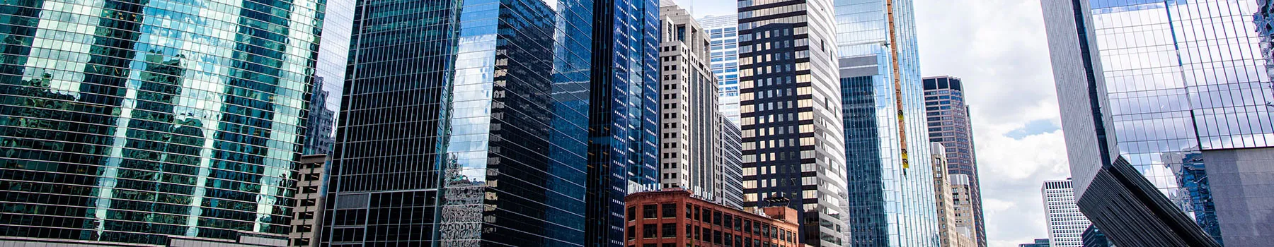 A group of Chicago skyscrapers that line the Chicago River reflect the afternoon sun.