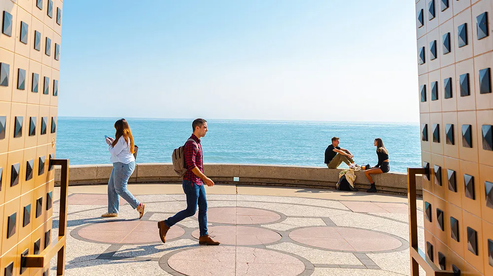 Loyola students hang out and go for a walk by lake and information commons