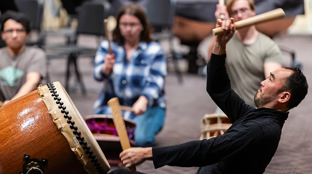 Kaoru Watanabe, artist in residence for the Department of Fine and Performing Arts, teaches percussion students on Japanese Taiko drums