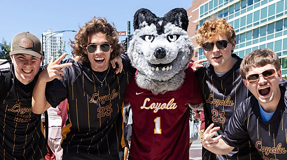 A group of young men surrounding Lu Wolf, stop to pose with energetic expressions on their way to Hoyne Field.
