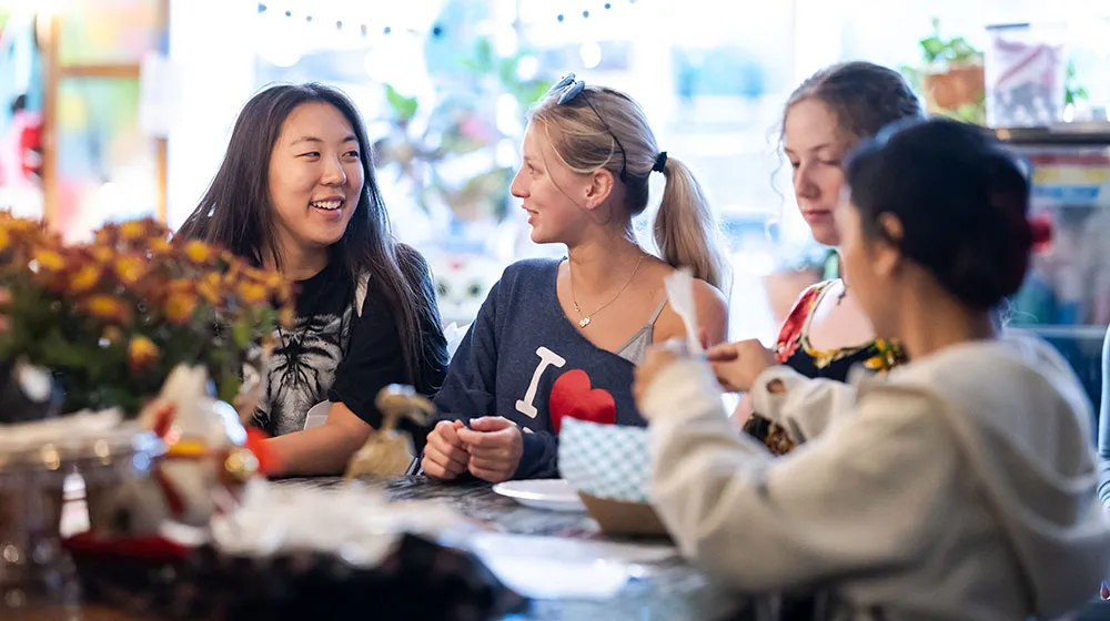 A group of students enjoy food together at a local cafe.