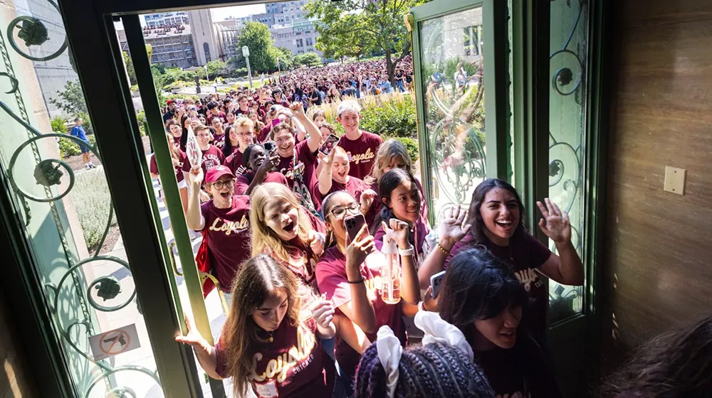 Students walk through the iconic patina doors of Cudahy Library to celebrate Student Convocation 2025 Students walk through the iconic patina doors of Cudahy Library to celebrate Student Convocation 2025