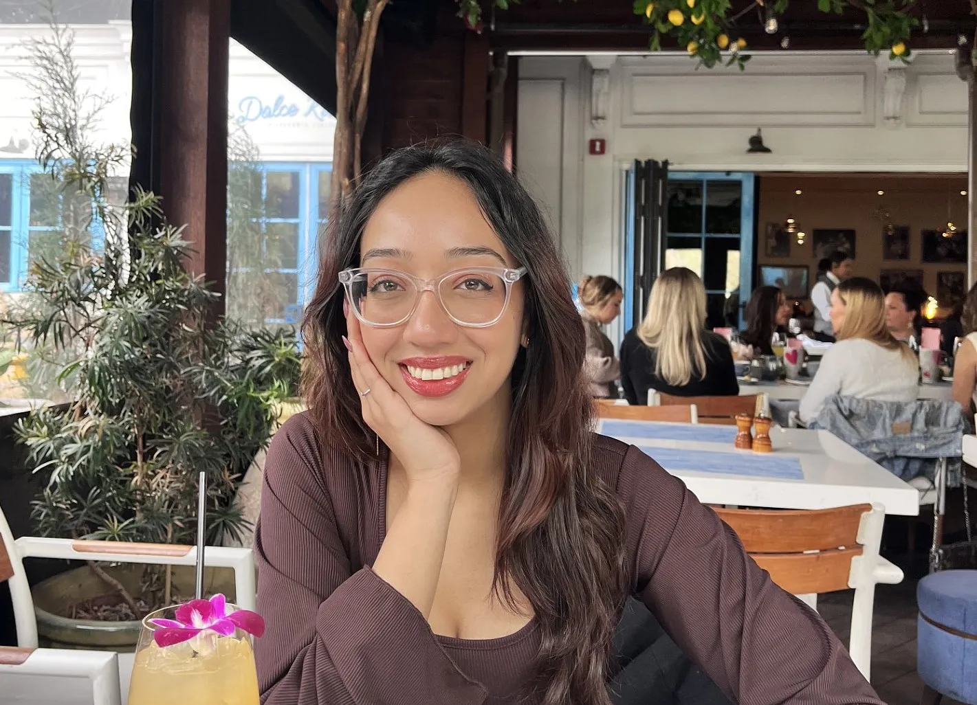 Young woman with dark hair, smiling in a restaurant Young woman with dark hair, smiling in a restaurant