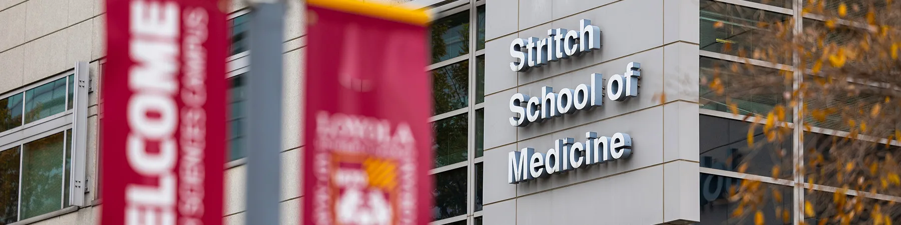 Stritch metal signage next to Loyola banners