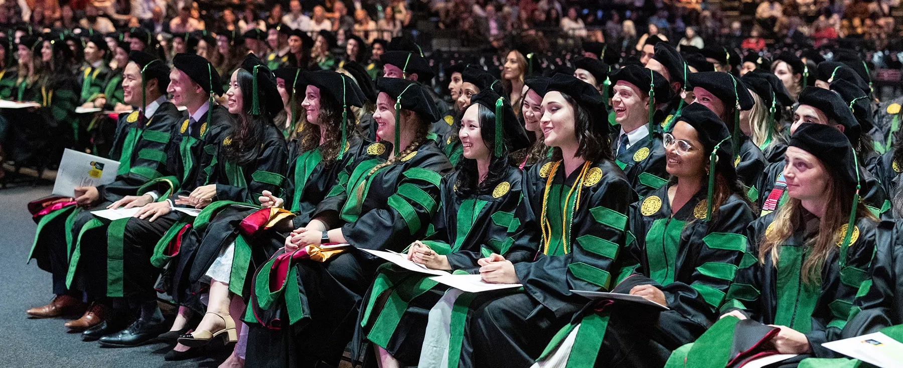 Members of the Stritch Class of 2026 wearing their cap and gowns and smiling during their Commencement Ceremony