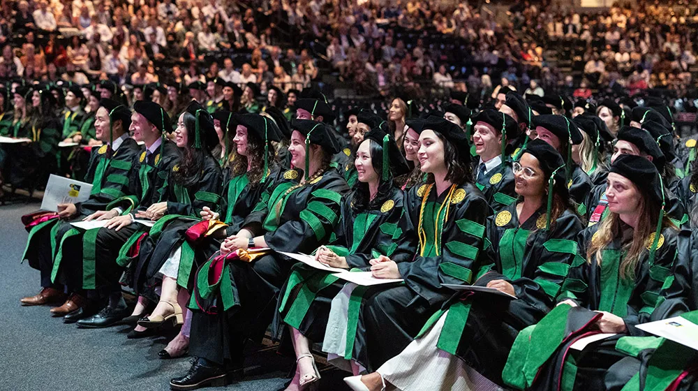 Members of the Stritch Class of 2026 wearing their cap and gowns and smiling during their Commencement Ceremony.