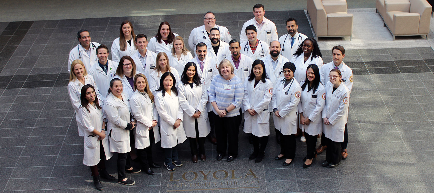 Faculty members wearing white coats in group photo