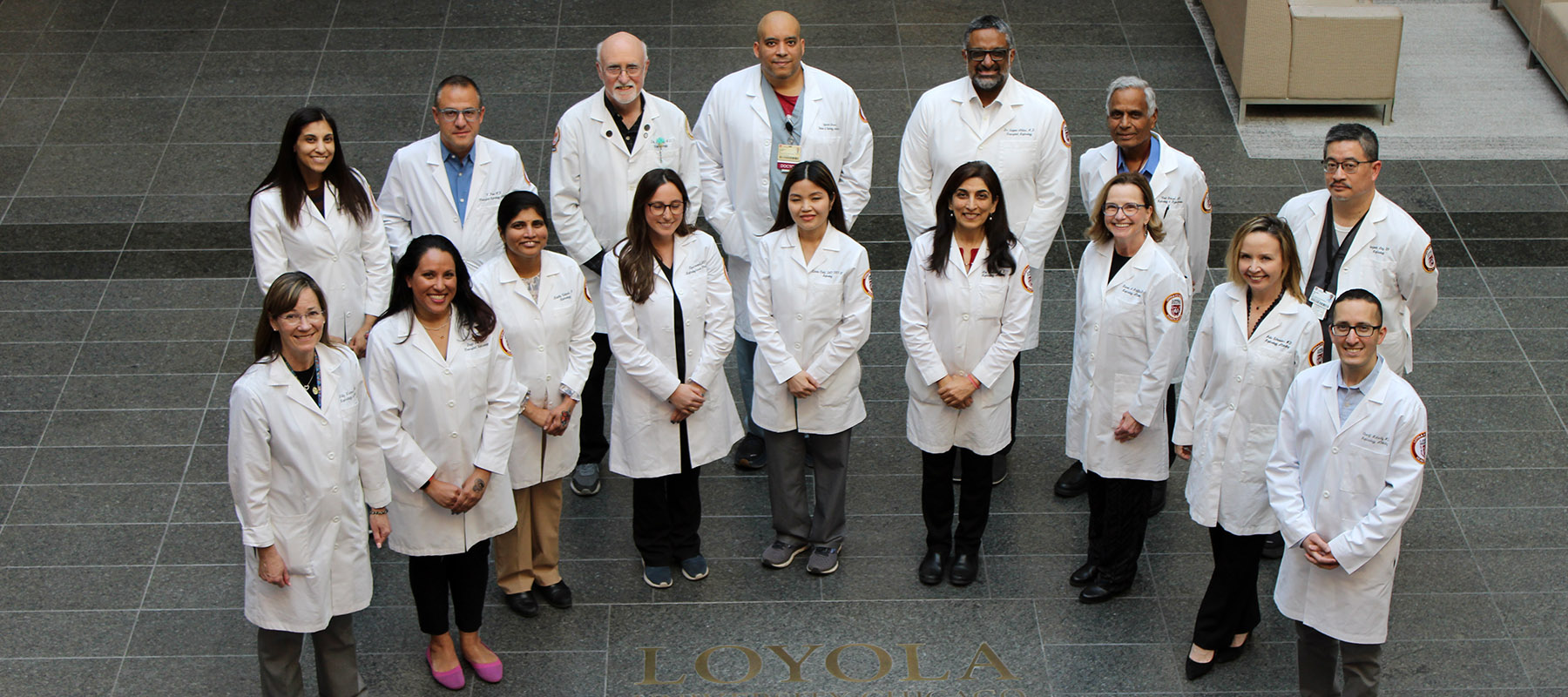 Faculty members wearing white coats in group photo