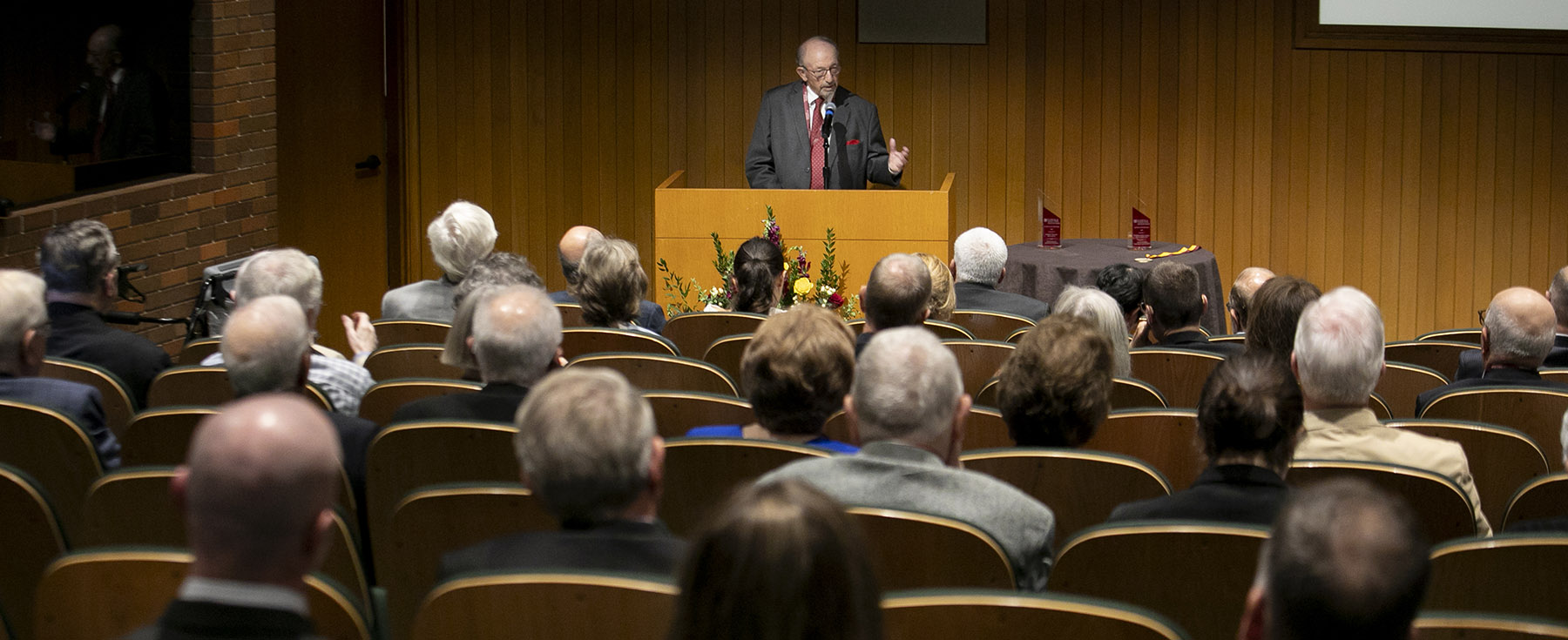 Award recipient standing at a podium speaking to attendees of an awards ceremony