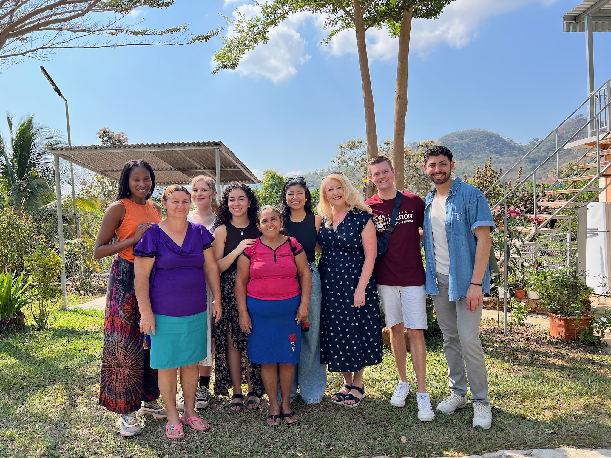 Loyola ABSN students and staff pose for a picture with community members in El Salvador.
