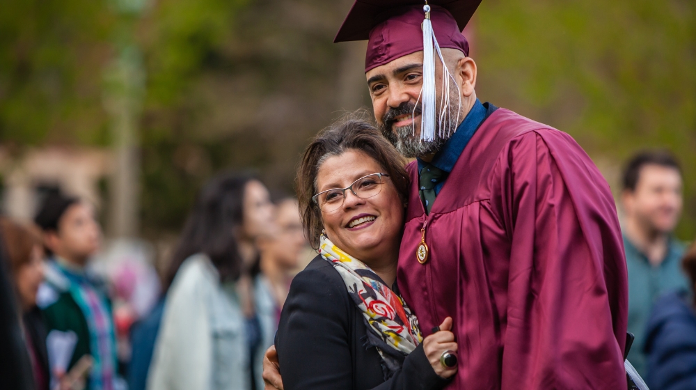 SCPS graduate celebrates commencement with a family member at Loyola University Chicago