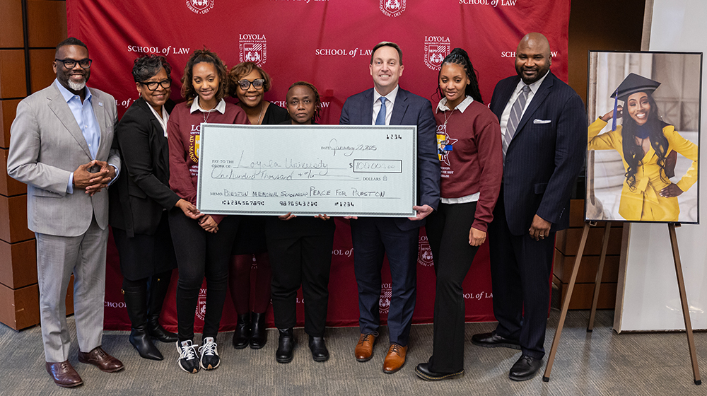A $100,000 check is presented during the Areanah Preston Memorial on January 22, 2025
