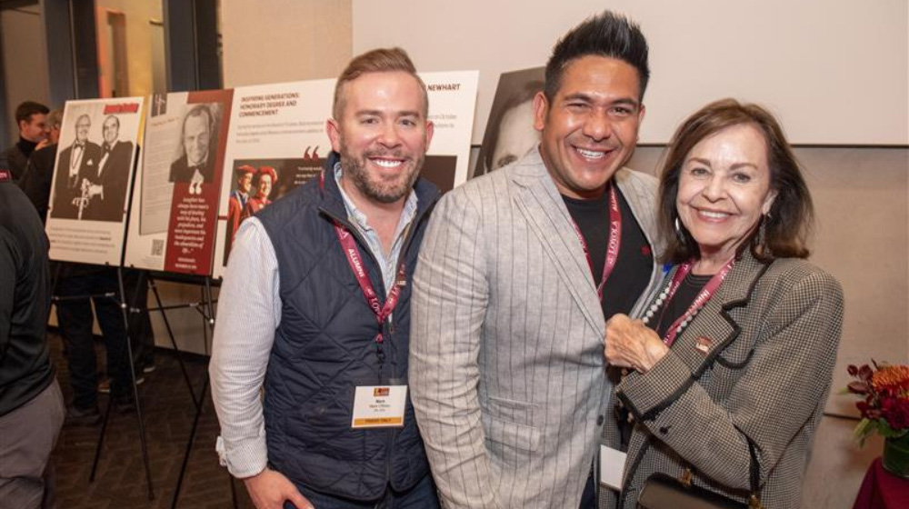 Three alumni from the Class of 2005 socialize at a reunion event