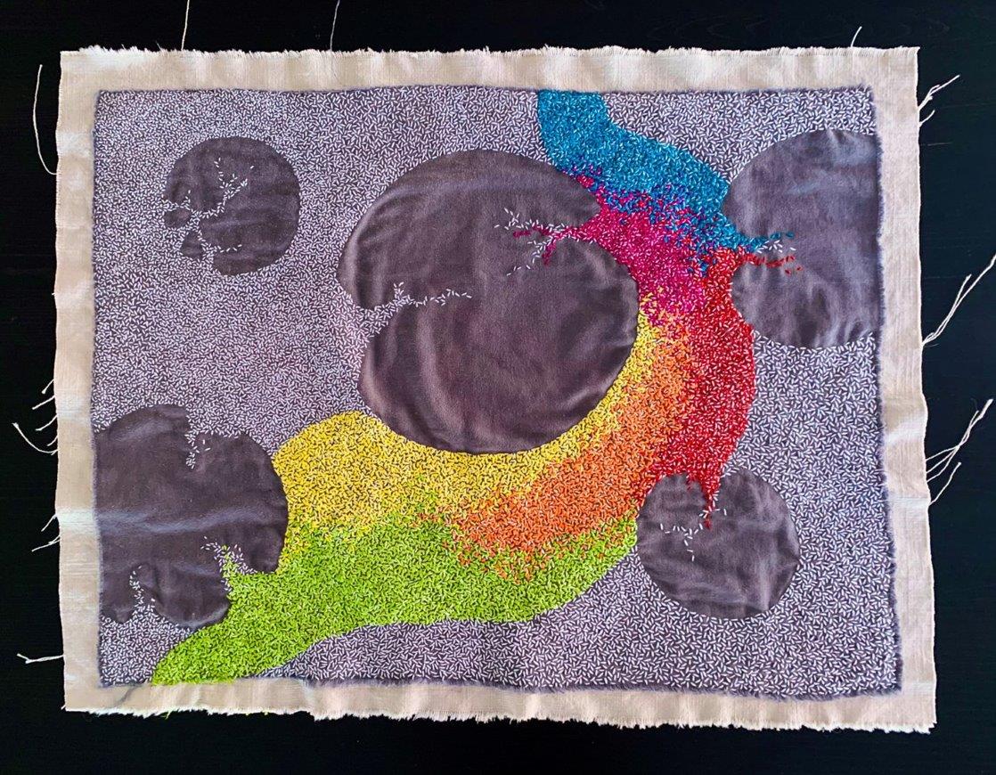 Textile artwork submitted to the Biology Department’s “Beauty in Biology” competition, featuring an abstract, embroidered anatomical heart in bright r