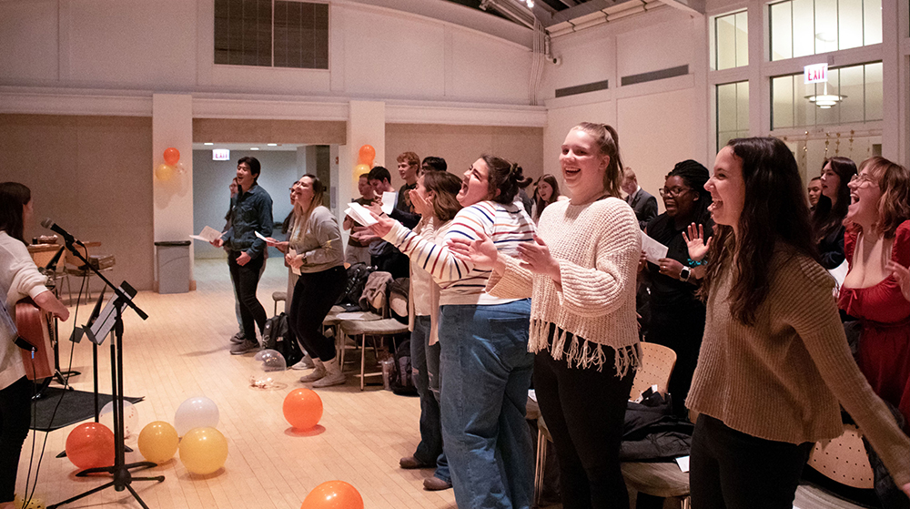 Group of people standing and singing together during a Protestant worship gathering indoors
