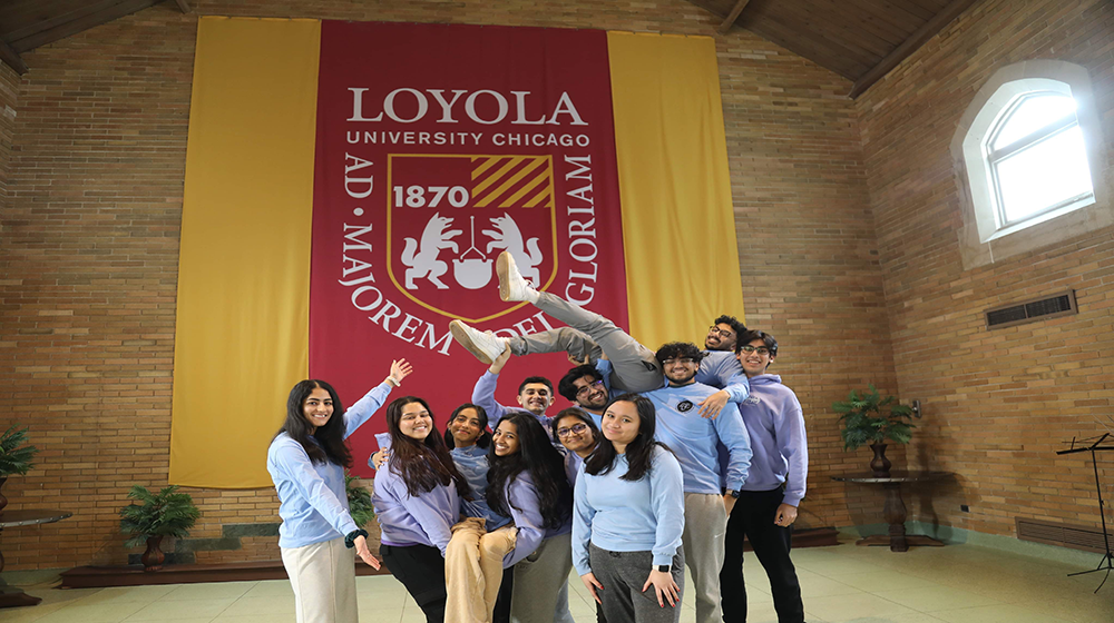Group of students clustered together smiling