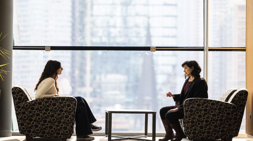 A student and career advisor sitting and talking across a table