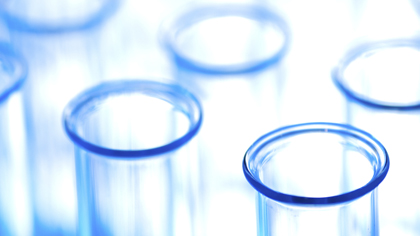 Close-up of empty laboratory test tubes with a blue tint.